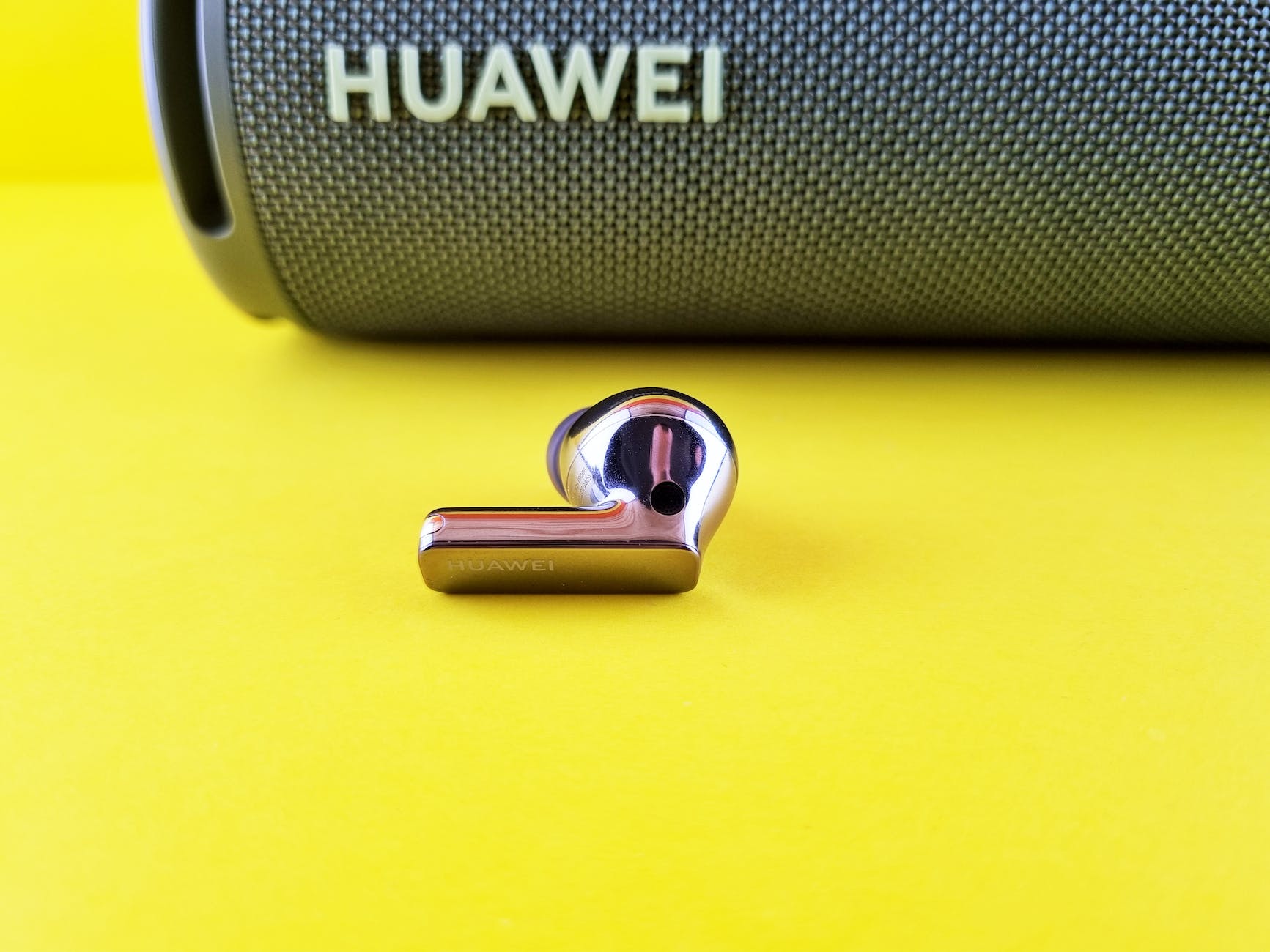 huawei earbud on yellow surface